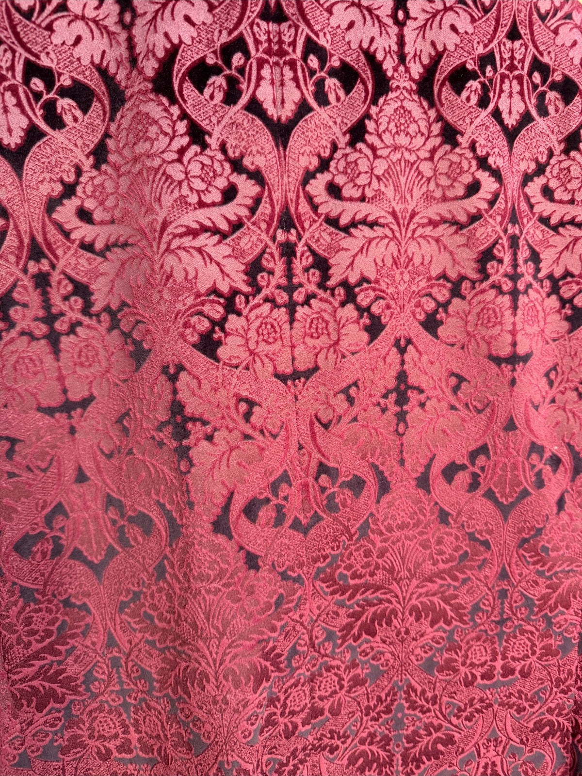 Burgundy damask jacquard fabric macro — real photo