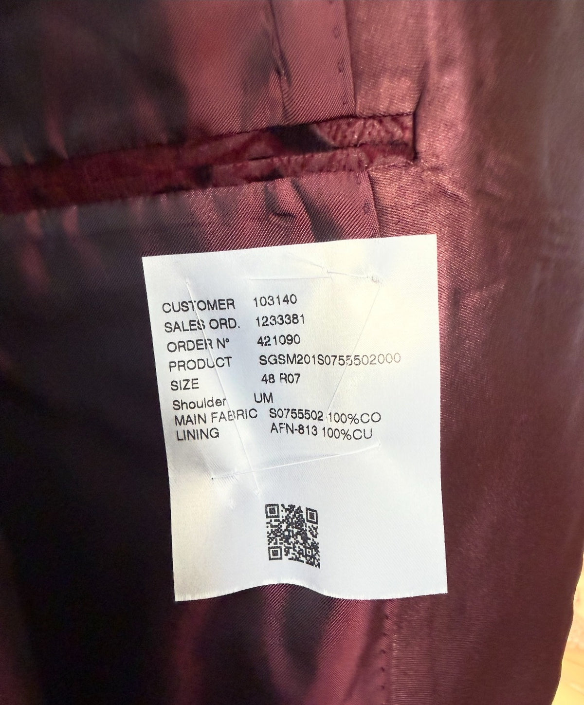 Interior spec label — 100% cotton, cupro lining — real photo