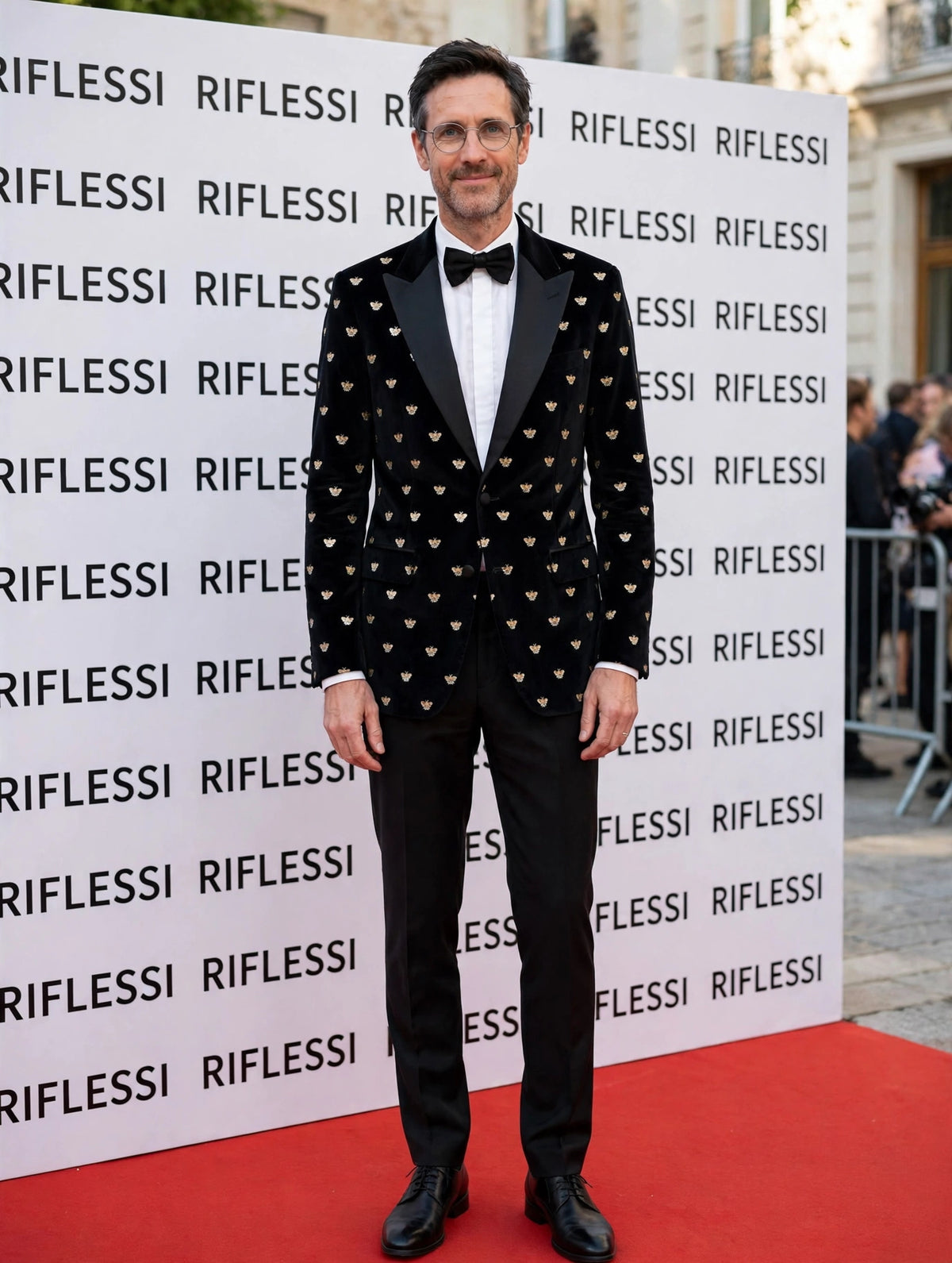 Sartorio black and gold bee cotton tuxedo jacket on the model at the Riflessi wall