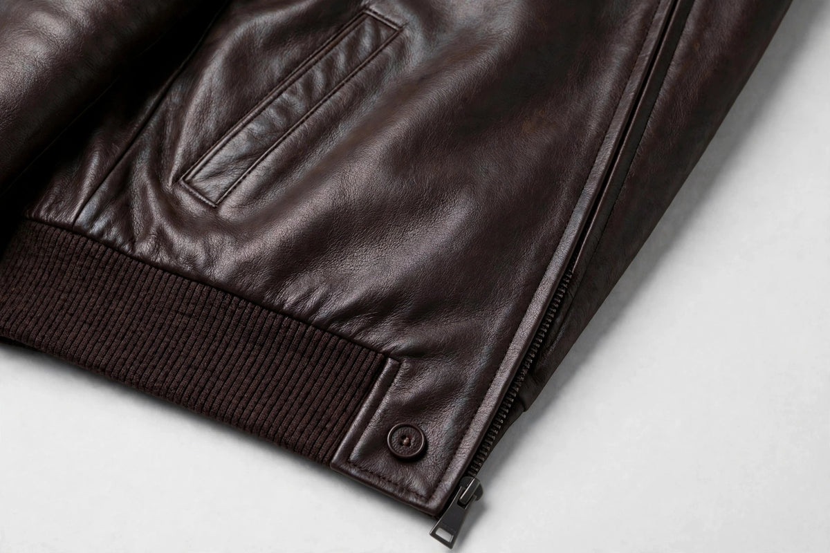 Kired PISA lambskin bomber — slanted welt pocket, ribbed hem and snap button, detail